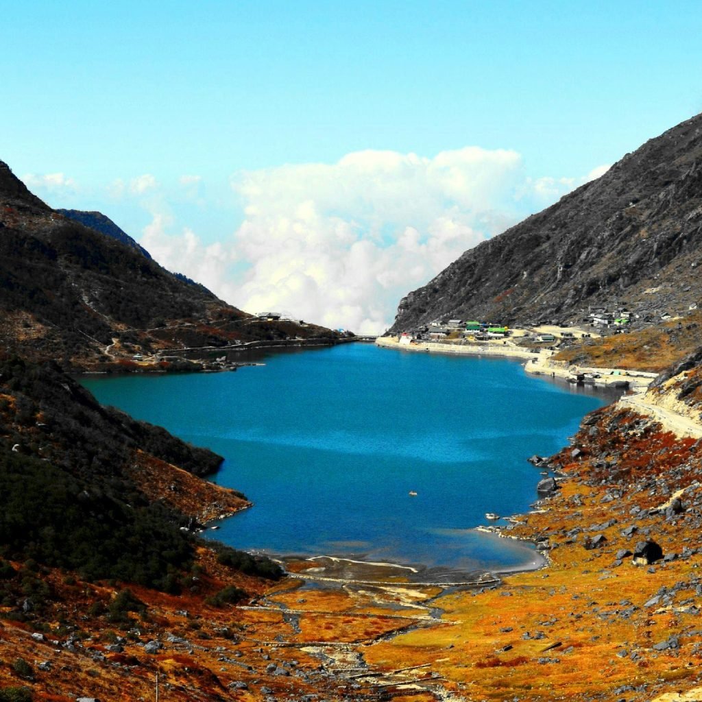 Stunning view of serene lake surrounded by rugged mountains in East Sikkim, India.